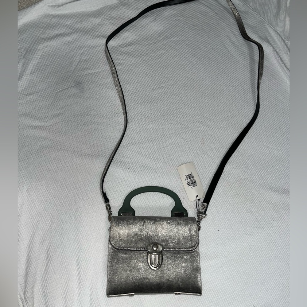 Euro club shoulder bag. Suede like fabric outside, leather-ish inside.3”X4”(?)